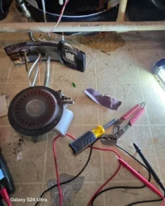 A real-time CCTV video monitor showing a root-clogged sewer pipe during a commercial plumbing inspection by JC Handyman Services in Central Indiana.