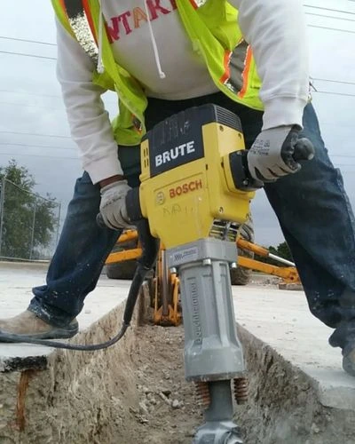 JC Handyman technician performing a chemical descaling on a high-capacity commercial water heater to remove calcium buildup in an Indianapolis facility.